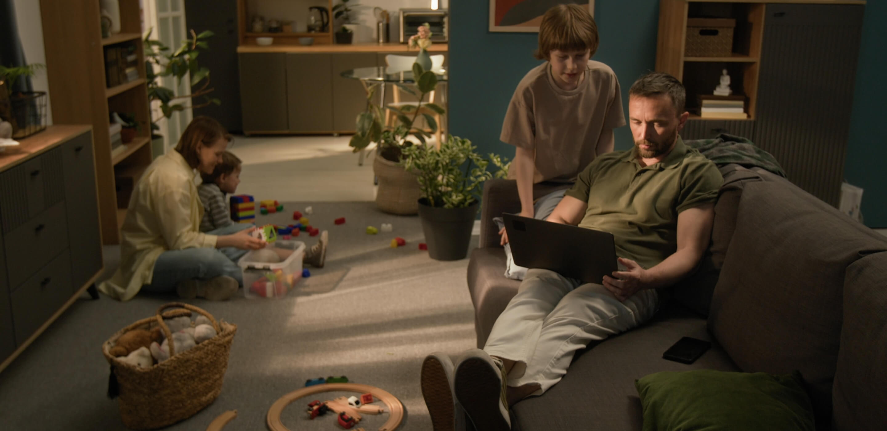 A family relaxing in a comfortable sitting room, illustrating the home energy upgrade benefits of the Warmer Homes Scheme in Ireland.
