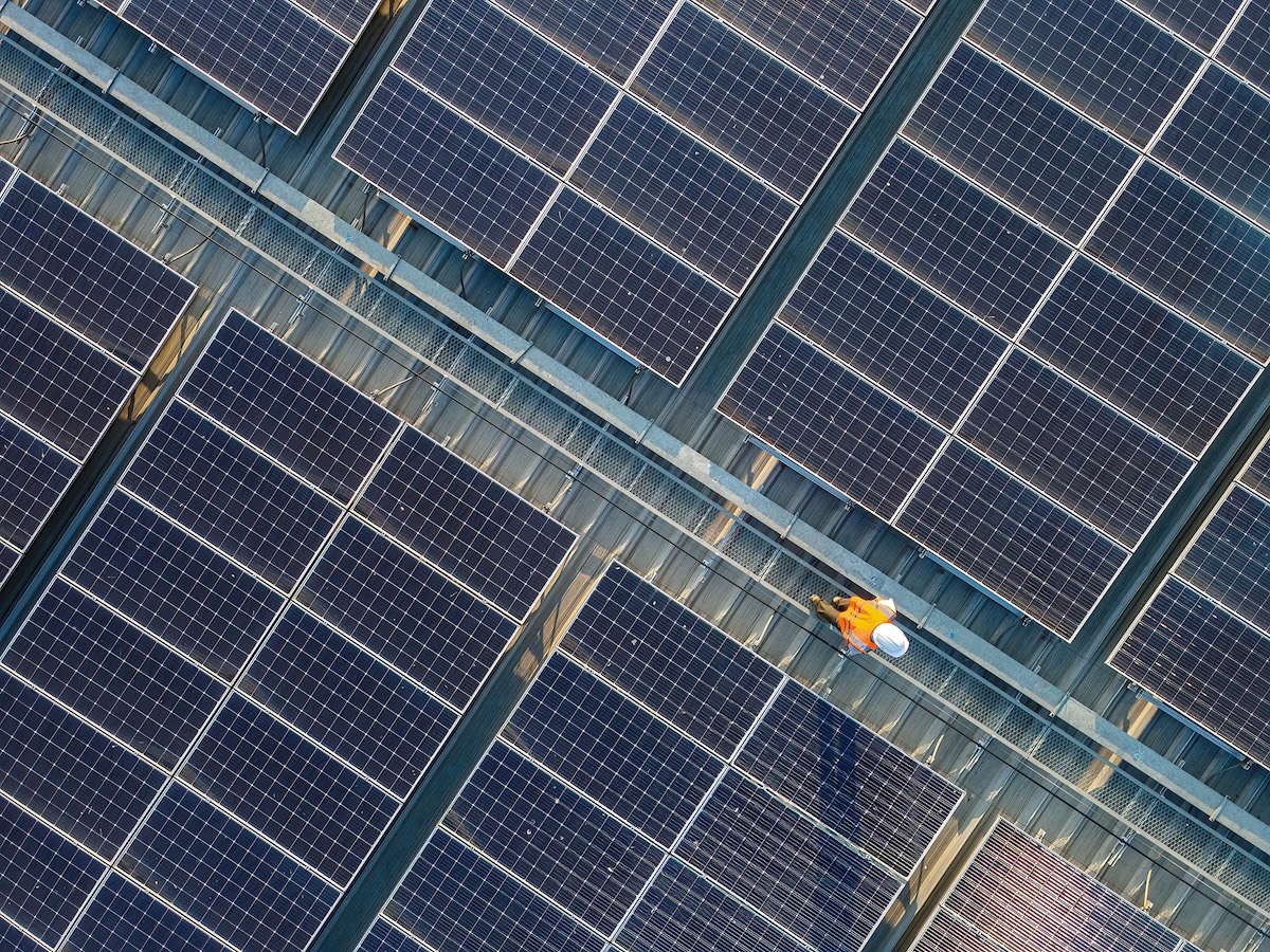 A view of a NetZero Group technician performing commercial solar panel servicing in Ireland.